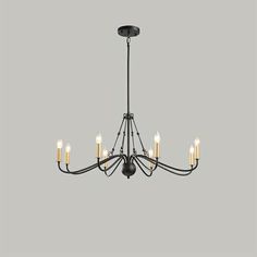 a black chandelier with five lights hanging from it's center and four arms