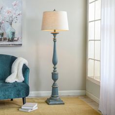 a living room with a blue chair and lamp