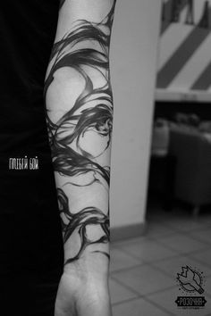 a woman's arm with black and white ink on the inside of her arm