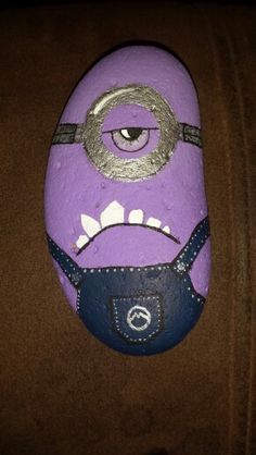 a close up of a purple rock with an evil face on it