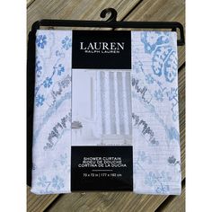 the lauren bedding set is in white and blue with floral designs on it, along with two matching pillow cases