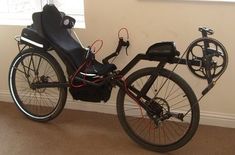 a bicycle parked next to a window in a room with carpeted floor and white walls