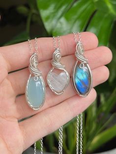 "💙🌊 Ocean Blues Crystal Necklaces 🌊💙 * Wrapped in Sterling Silver wire✨ Chalcedony: 1 1/2\" tall Rainbow Moonstone: 1 5/16\" tall Labradorite: 1 1/2\" tall  * Each necklace comes with an 18\" Sterling Silver chain  🌿 Follow me on Instagram & TikTok @crystal.lune" Adjustable Silver Labradorite Crystal Necklace, Silver Teardrop Gemstone Crystal Necklace, Handmade Silver Labradorite Jewelry, Nickel-free Moonstone Necklace For Healing, Nature-inspired Sterling Silver Wire Wrapped Necklaces, Nature-inspired Wire Wrapped Sterling Silver Necklaces, Handmade Dainty Crystal Necklace As Gift, Dainty Handmade Crystal Necklace Gift, Dainty Handmade Crystal Necklace For Gift