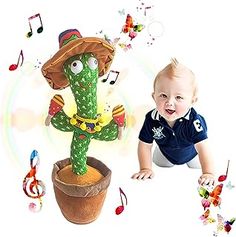 a baby sitting next to a fake cactus with music notes around it's neck