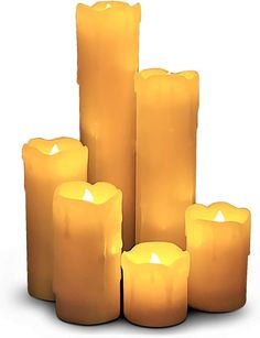 several yellow candles sitting next to each other