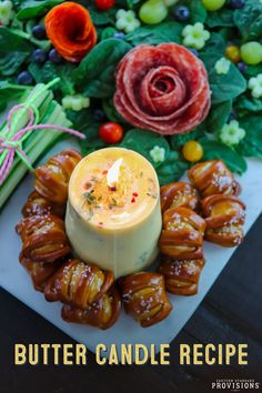 a candle is sitting on top of some appetizers