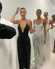 the models are all dressed up in black and white outfits, while one woman is taking a selfie