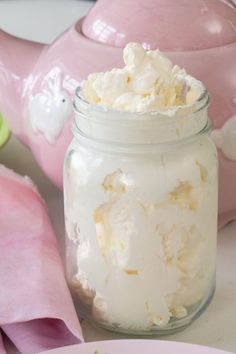 a jar filled with whipped cream sitting on top of a table