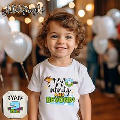 a young child standing in front of balloons