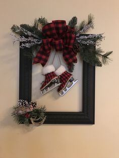 a christmas wreath hanging on the wall with skis and snowflakes attached to it