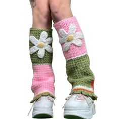 the legs of a woman wearing crocheted socks with flowers on them