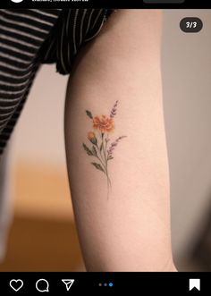 a small flower tattoo on the right side of the thigh, with an arrow in the middle