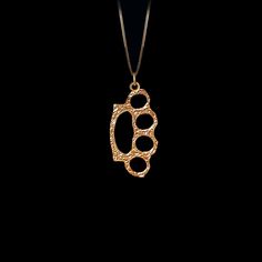 Elevate your style with our Gold Knuckle Duster Pendant. This solid gold necklace showcases exquisite craftsmanship, symbolizing boldness and edgy fashion. The knuckle duster pendant is more than just jewelry; it's a fine representation of streetwear-inspired elegance and the allure of urban culture, also available in 18k yellow gold. PENDANT INFORMATIONThis pendant is made of real, solid gold.• Made in USA• Material: 14k or 18k solid gold• Finish: polished• Height: 1.46" (37 cm) x Width: 0.72" Gold Jewelry For Streetwear, Hand Cast Yellow Gold Jewelry, Hand Cast Brass Pendant Jewelry, Hand-cast Brass Pendant Jewelry, Luxury Gold Jewelry For Streetwear, Gold Metal Necklaces For Streetwear, Handmade Brutalist Gold Jewelry, Handmade Gold Brutalist Jewelry, Hand Cast Brutalist Metal Jewelry