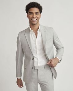 A modern twist on the classic grey suit thanks to its light colouration, you can't go wrong with this blazer for a flattering way to complete your outfit. Matching suit pants and jogger pants available.  - Slim fit for a close-to-the-body silhouette - Stretch fabric blend - Notch collar - Two-button closure - Chest pocket and flap pockets - Inner pockets - Back vent - Lined - Sleeve length: 35'' from center back (size 40) - Body length: 28.75" from center back (size 40) Light Grey Suit Men Wedding Party, Light Colour Blazers For Men, Light Gray Suits For Men, Light Grey Suit Men Wedding, Mens Suits Wedding Guest, Gray Suits For Men, Light Grey Suit Men, Men Formal Outfit Classy, Beige Suits Wedding