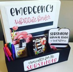 a box filled with assorted items on top of a white table next to a sign