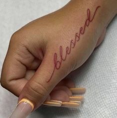 a woman's hand with the word believe written on it