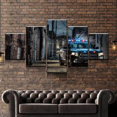 a police car parked in front of a brick wall with the lights on at night