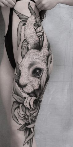 a woman's thigh with an animal tattoo on it