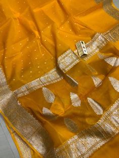 Exclusive Pure Chiffon Georgette Banarasi silk Saree With floral zari work pattern.PRODUCT DETAILSAuction For: 1 Saree with Blouse PieceColor: As shown in the pictureCondition: NewWork: FloralSaree length : 5.5 metersBlouse length : 0.8 metersWashing Instructions: Dry Clean OnlyOccasions: Wedding Wear, Party Wear, Festive Wear, Durga Puja, Indian Wear, Sangeet Wear, Bridal Wear, Chrismas Day, Mothers Day, Haldi Wear.Fall and Pico: On request (Please contact for fall and piku work)Blouse stitchin Affordable Banarasi Silk Dupatta, Luxury Banarasi Silk Fabric For Diwali, Gold Georgette Blouse Piece With Zari Work, Gold Georgette Blouse Piece With Dupatta, Transitional Gold Georgette Blouse Piece, Unstitched Gold Georgette Blouse Piece, Traditional Gold Georgette Blouse Piece, Transitional Georgette Blouse Piece With Zari Weaving, Diwali Georgette Blouse Piece With Zari Weaving