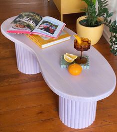 a coffee table with an orange slice and book on it