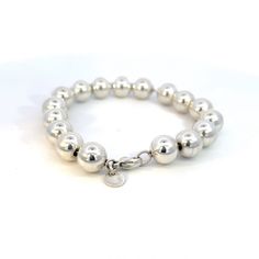 Authentic Tiffany & Co Estate 10 mm Ball Bracelet Size 7.5" Sterling Silver 10 mm TIF591This elegant Authentic Tiffany & Co bracelet is made of sterling silver and weighs 19.17 grams.TRUSTED SELLER SINCE 2002PLEASE SEE OUR HUNDREDS OF POSITIVE FEEDBACKS FROM OUR CLIENTS!!FREE SHIPPING!!DETAILSStyle: Ball BraceletLength: 7.5 InchesBall Size: 10 mmWeight: 19.17 GramsMetal: Sterling SilverMetal Purity: 925We try to present our Tiffany estate items as best as possible and most have been newly polish Classic Sterling Silver Bracelet With Beads, Classic Silver Bracelets With 8mm Beads, Sterling Silver Bracelet With 8mm Beads, Modern Silver Jewelry With 8mm Beads, Luxury Silver Bracelet With 8mm Beads, Tiffany And Co Bracelet, Sparkly Things, Ball Bracelet, Tiffany And Co