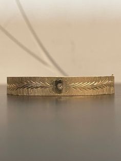 This stunning 14K yellow gold hinged bangle bracelet has beautiful engraving work on it.  It has a flower on each side and gorgeous etching around the entire bangle.  This bracelet is in excellent condition and weighs 13.8 grams. Antique 14k Gold Bracelet Engraved, Antique Engraved 14k Gold Bracelet, Victorian Gold Wedding Bracelet Stamped 14k, Elegant Etched Bangle For Wedding, Victorian Gold Bracelet For Wedding, Antique Engraved Yellow Gold Cuff Bracelet, Vintage Yellow Gold Engraved Cuff Bracelet, Antique Engraved Yellow Gold Bracelet, Heirloom 14k Gold Engraved Bangle