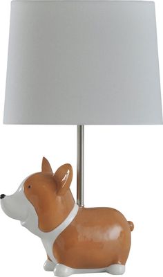 a ceramic dog lamp with a white shade on it's head and neck, sitting next to a light bulb