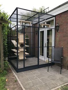 a house with a large bird cage in the back yard