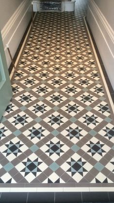 a tiled hallway with an open door leading to another room