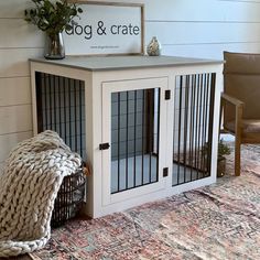 a dog crate with its door open next to a chair and rug on the floor