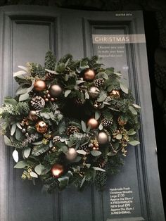 a christmas wreath on the front door of a house