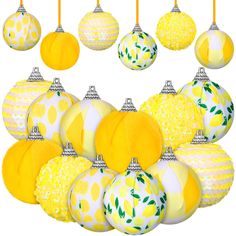 a bunch of yellow and white ornaments hanging from strings