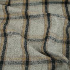 a close up view of a plaid fabric with yellow and black lines on it's surface