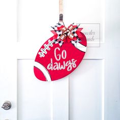 a door hanger with the words go dawgs hanging from it's side