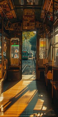 the inside of a train car with its doors open and sunlight shining on the floor