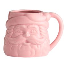 a pink ceramic mug with a santa clause on it's face and beard in the middle