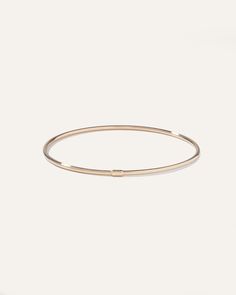 Made from 14k gold, this bangle features a sleek, slim, slightly oversized design. Worn alone or stacked with others, its polished finish will shimmer with you from daytime duties to nighttime fun. Modern Hoop Bangle For Everyday, Modern Hoop Bangle For Everyday Wear, Everyday 14k Gold Hoop Bracelets, Minimalist 14k Gold Hoop Bangle, Minimalist Gold Hoop Bracelet, Modern 14k Gold Hoop Bangle, Modern 14k Gold Hoop Bracelets, Flexible Modern 14k Gold Bangle, Minimalist Yellow Gold Hoop Bracelet