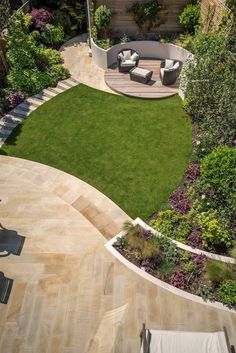 an aerial view of a backyard with lawn and seating area