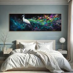 a large white bed sitting under a painting on the wall