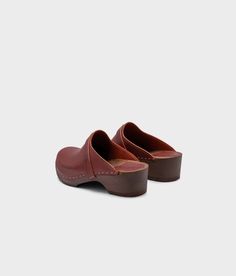 The best clogs for all occasions. Stylish with a nod to the past and an eye towards the future. With a handcrafted design, versatile colors, and comfortable wooden soles, these classic wooden clog mules will last you for years to come. Clog measurements:Heel height: 1 3/4” (4.5 cm)Toe height: 1 5/8″ (4.1 cm)Fit:RegularLeather:Vegetable tanned leatherClogs consist of:Base: European Lime WoodSole: Rubber soleFastening: Staples Clog Mules, Cork Sandals, Wooden Clogs, Clog Sandals, An Eye, Boot Shop, Shop Sandals, Mule, Cognac