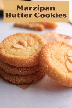 some cookies are stacked on top of each other with the words marzipan butter cookies above them