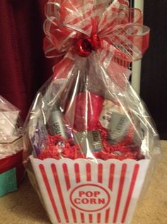 a red and white popcorn bucket filled with snacks