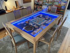 a table that has some kind of board game on it with blue lights in the middle