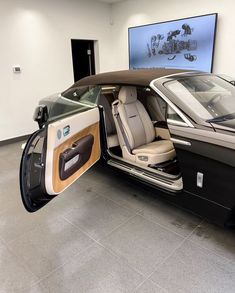 a car with its doors open in a showroom