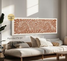 a living room scene with focus on the couch and wall art hanging above it's sofa