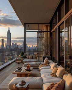 a balcony with couches and tables overlooking the city