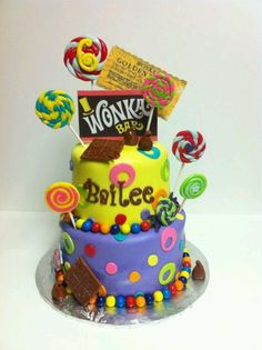 a birthday cake decorated with candies, lollipops, and candy bars