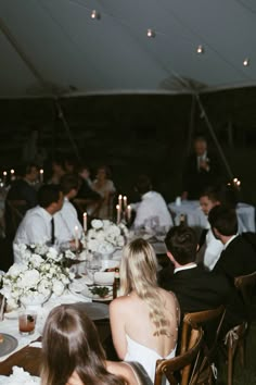 a group of people sitting around a dinner table