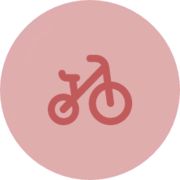 a pink circle with an image of a bicycle on it's front and side