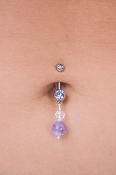 "Strengthen your intuition with this amethyst dangle belly ring. Made with ethereal shades of lilac, deep purples, holographic clears and hints of creme. The vibe of this piece is reminiscent of a magical woodland <3 Amethyst also happens to be the birthstone of February! Made with 7/16\" inch (11 mm) length bar; ball sizes are 5mm and 8mm. Bar is 14 gauge. To prolong lifetime of piece, remove before showering/bathing/swimming and keep in a cool, dry environment! Handmade in Davis, CA! First Pho Purple Belly Ring, Purple Belly Piercing, Hypoallergenic Purple Drop Jewelry, Purple Hypoallergenic Drop Jewelry, Adjustable Dangle Belly Rings, Purple Birthstone Drop Jewelry, Purple Internally Threaded Jewelry As A Gift, Purple Internally Threaded Jewelry Gift, Hypoallergenic Amethyst Dangle Jewelry